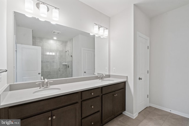 bathroom with tile patterned floors, vanity, and a shower with shower door