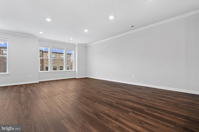 spare room featuring dark hardwood / wood-style flooring and ornamental molding