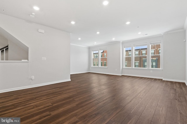 unfurnished living room featuring dark hardwood / wood-style floors and ornamental molding