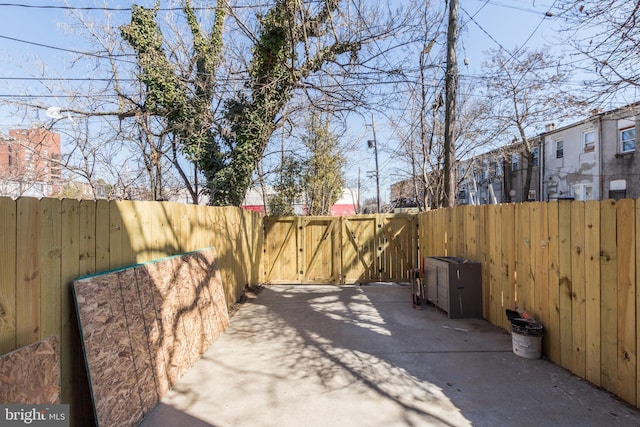 view of patio featuring a fenced backyard and a gate