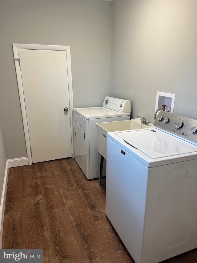 laundry room featuring dark hardwood / wood-style flooring and washer and clothes dryer