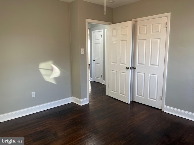 unfurnished bedroom with dark hardwood / wood-style floors