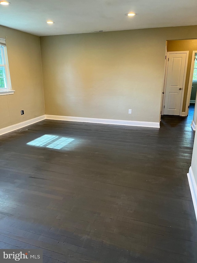 spare room with dark hardwood / wood-style floors