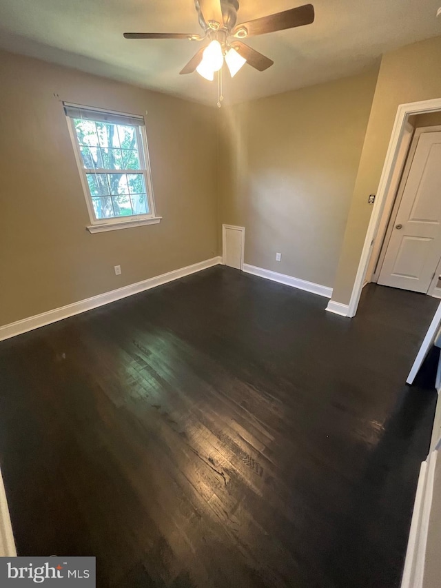 unfurnished room featuring dark hardwood / wood-style flooring and ceiling fan