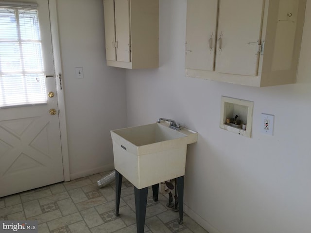 washroom with cabinets, sink, and hookup for a washing machine