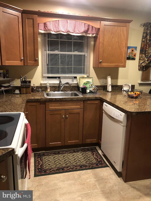 kitchen featuring white appliances and sink