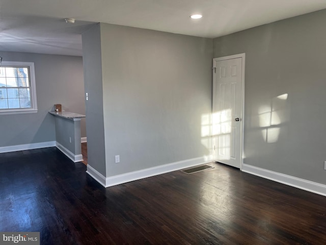 spare room with dark hardwood / wood-style flooring