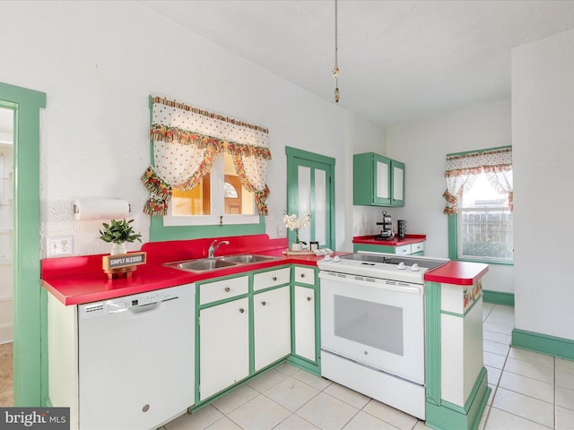 kitchen with kitchen peninsula, light tile patterned floors, white appliances, and sink