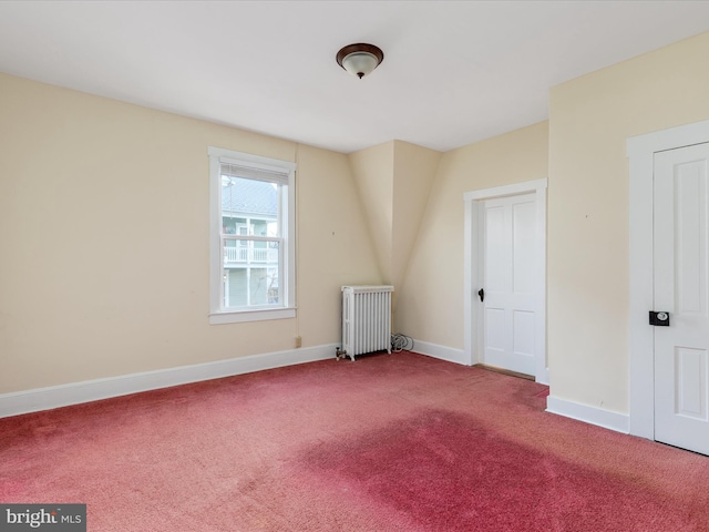 additional living space featuring carpet floors and radiator