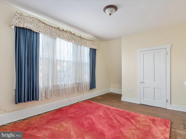 unfurnished room with dark hardwood / wood-style floors