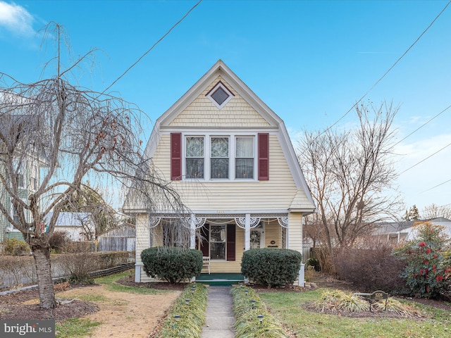 view of front of property with a porch and a front yard