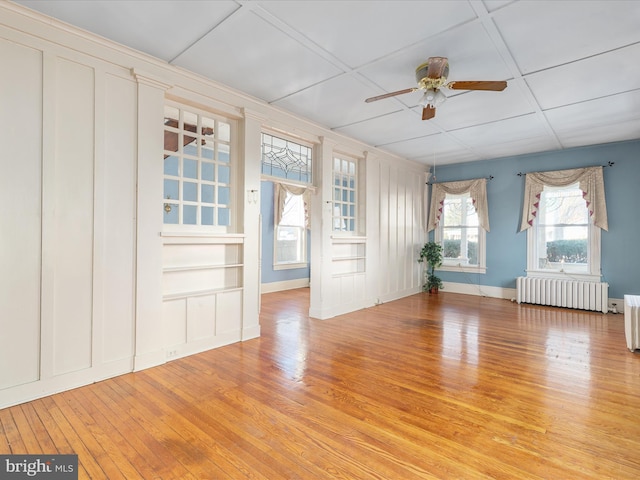 interior space featuring light hardwood / wood-style flooring, radiator, and ceiling fan