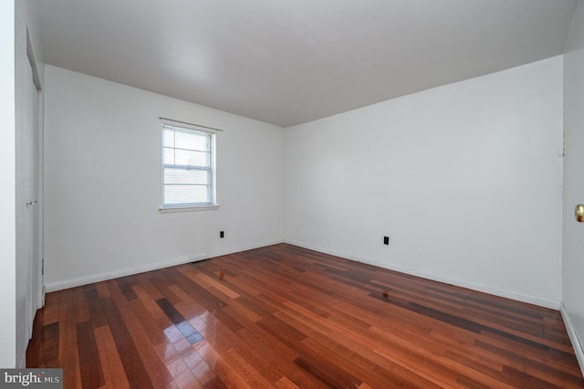 spare room featuring dark hardwood / wood-style flooring