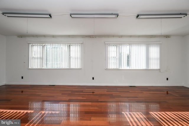 empty room with dark hardwood / wood-style floors