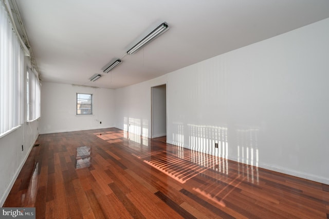 spare room with dark wood-type flooring