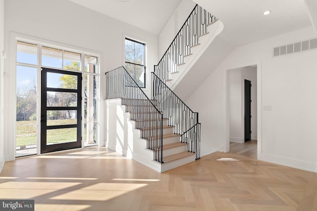 foyer with plenty of natural light and light parquet floors