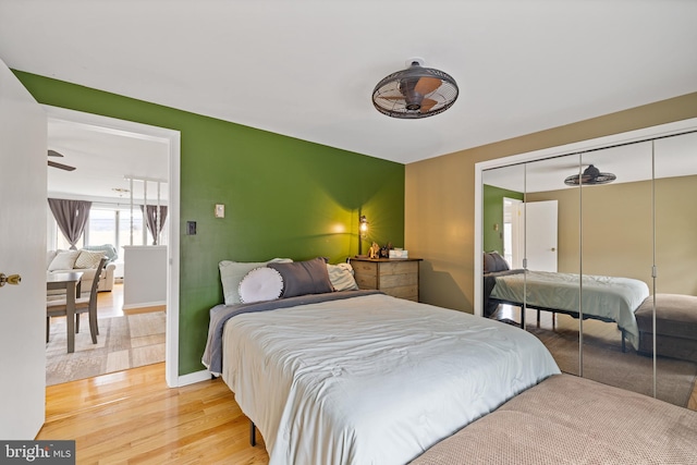 bedroom with light hardwood / wood-style floors and a closet