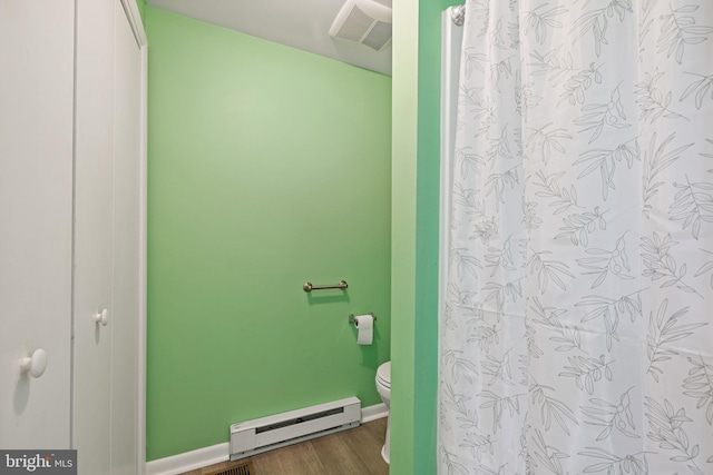 bathroom with a baseboard radiator, wood-type flooring, and toilet