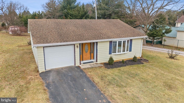 view of front facade featuring a garage and a front lawn