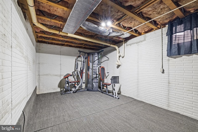 exercise room featuring brick wall