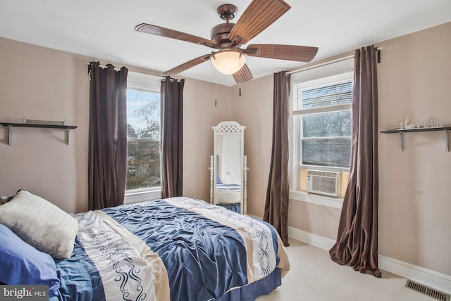 carpeted bedroom featuring ceiling fan and cooling unit