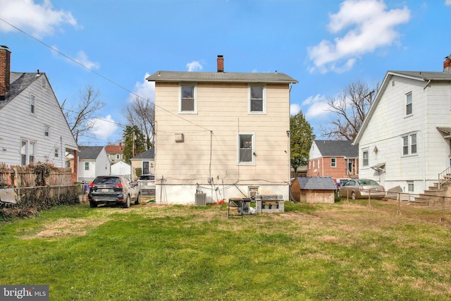 back of house featuring a yard