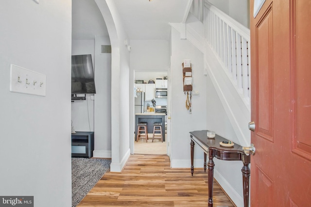 foyer with light hardwood / wood-style floors