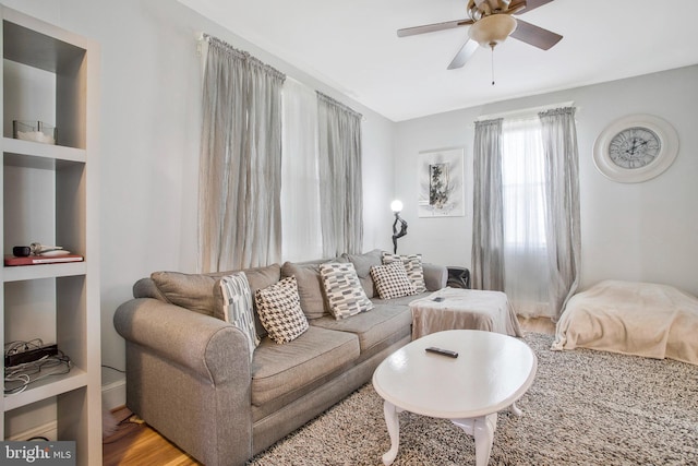 living room with ceiling fan and hardwood / wood-style floors