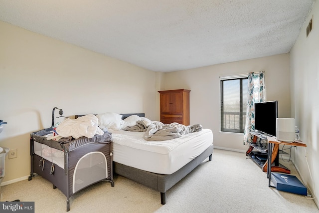 bedroom featuring carpet and a textured ceiling