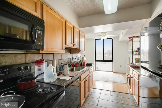 kitchen with black appliances, sink, ceiling fan, decorative backsplash, and light tile patterned floors