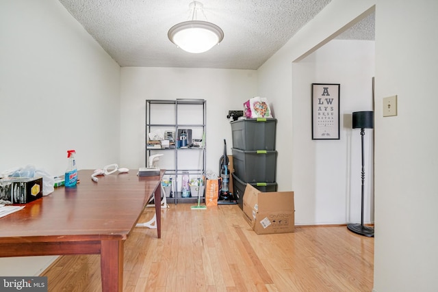 office with hardwood / wood-style floors and a textured ceiling