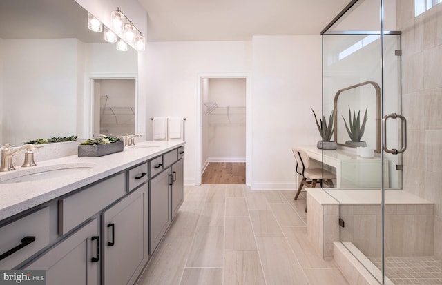 bathroom featuring vanity and an enclosed shower