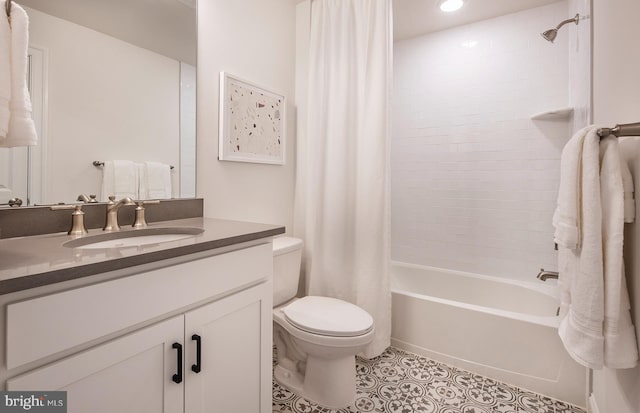 full bathroom featuring tile patterned floors, shower / bath combination with curtain, toilet, and vanity