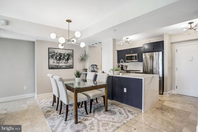 dining room featuring an inviting chandelier and sink