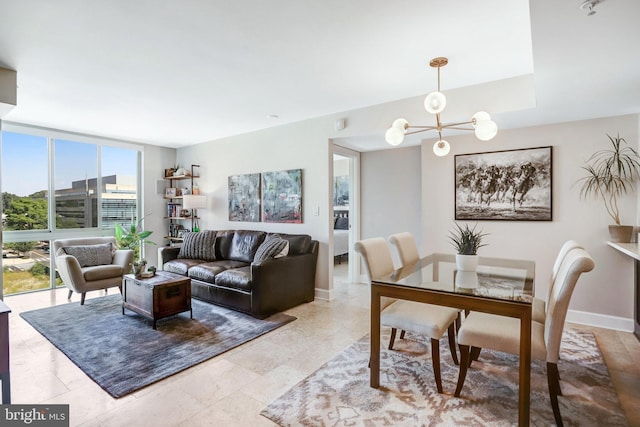 living room with a chandelier and expansive windows