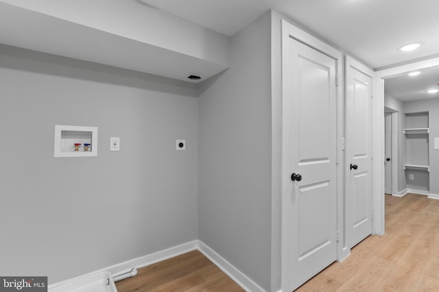 washroom with hookup for an electric dryer, washer hookup, and light hardwood / wood-style floors