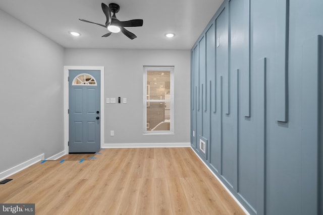 foyer with ceiling fan and light wood-type flooring