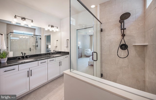 bathroom with tile patterned floors, vanity, and walk in shower