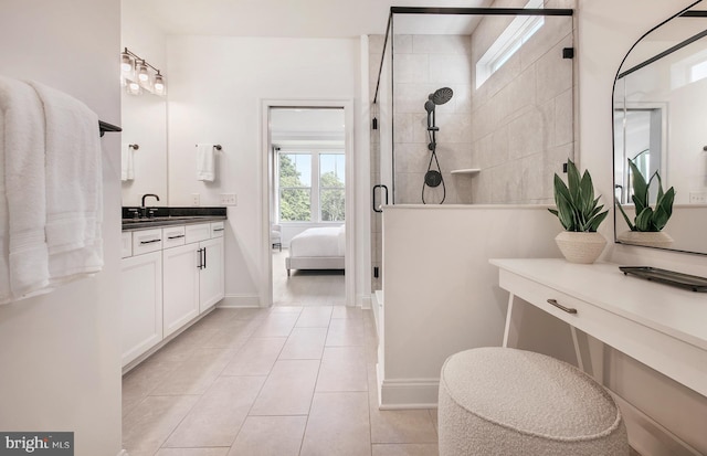 bathroom with tile patterned flooring, vanity, and a shower with shower door