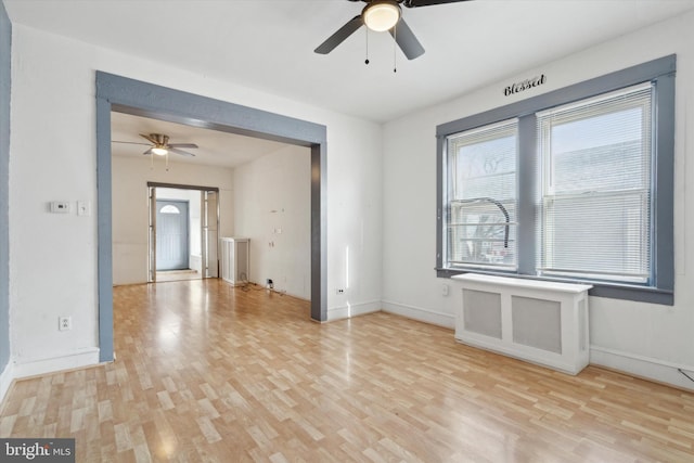 spare room featuring ceiling fan, plenty of natural light, and light hardwood / wood-style floors