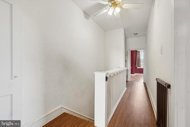 hallway with radiator and hardwood / wood-style flooring