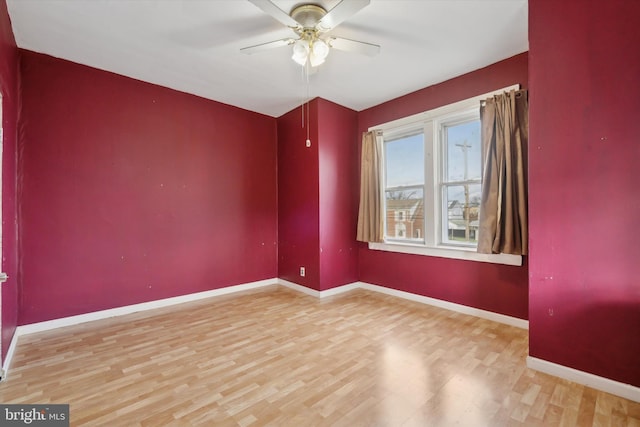 empty room with hardwood / wood-style flooring and ceiling fan