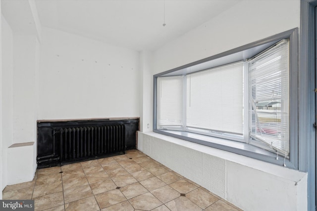 interior space with radiator and a wealth of natural light