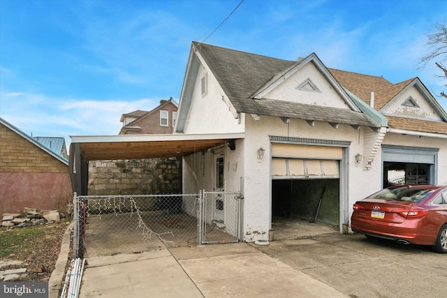 view of front of property with a garage and a carport