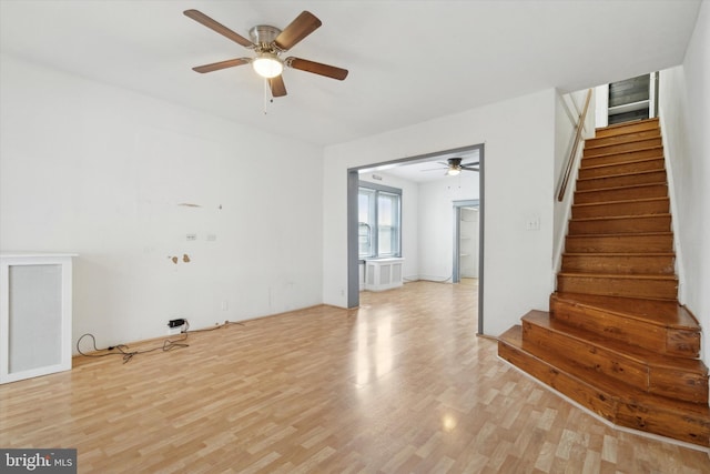 interior space with ceiling fan and light hardwood / wood-style flooring