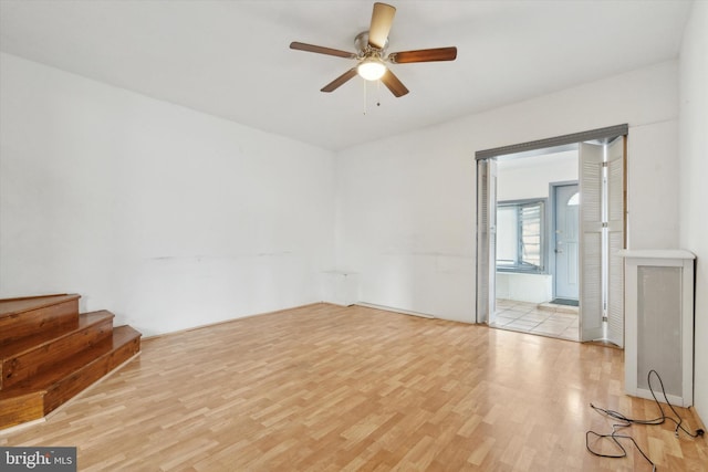 empty room featuring light hardwood / wood-style flooring and ceiling fan