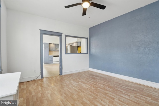 empty room featuring ceiling fan and hardwood / wood-style floors