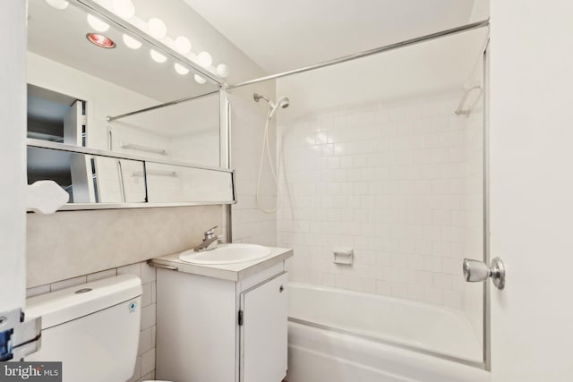 full bathroom with vanity, toilet, and tiled shower / bath