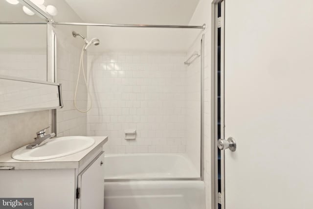 bathroom featuring vanity and tiled shower / bath