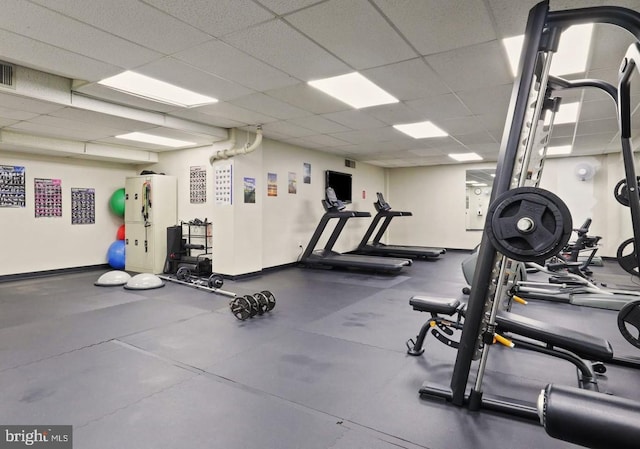 gym featuring a paneled ceiling